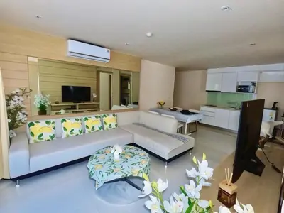 a living room with a couch and a kitchen at Beachfront Patong Hillside Modern Apartment in Patong Beach