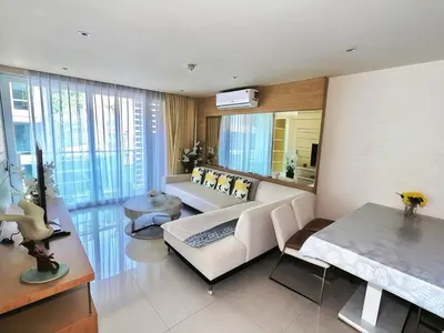 a living room with a white couch and a table at Beachfront Patong Hillside Modern Apartment in Patong Beach