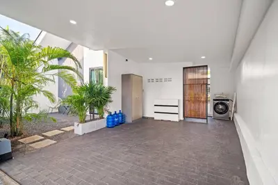 a hallway of a house with palm trees at Modern Zen Oasis in Phuket in Ban Saiyuan (1)