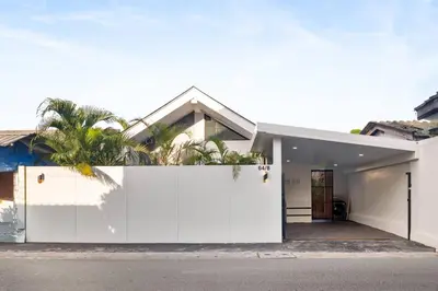 a white fence in front of a house at Modern Zen Oasis in Phuket in Ban Saiyuan (1)
