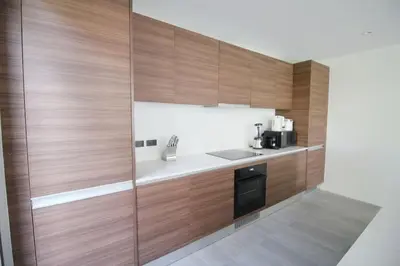 a kitchen with wooden walls and a counter with a sink at Modern Private Pool Villa - Peaceful Kamala Stay in Kamala Beach