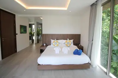 a bedroom with a large white bed with two pillows at Modern Private Pool Villa - Peaceful Kamala Stay in Kamala Beach
