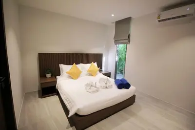 a bedroom with a bed with stuffed animals on it at Modern Private Pool Villa - Peaceful Kamala Stay in Kamala Beach