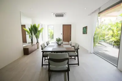 a dining room with a table and chairs at Modern Private Pool Villa - Peaceful Kamala Stay in Kamala Beach