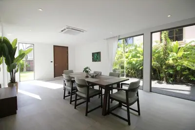 a dining room with a wooden table and chairs at Modern Private Pool Villa - Peaceful Kamala Stay in Kamala Beach