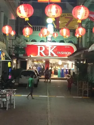 a group of people walking in front of a store at RK Boutique rooms in Patong Beach