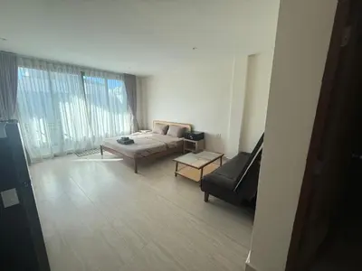 a living room with a couch and a chair at RK Boutique rooms in Patong Beach