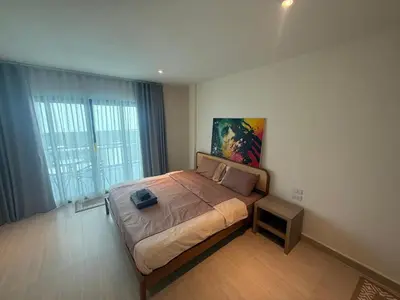 a bedroom with a bed and a painting on the wall at RK Boutique rooms in Patong Beach