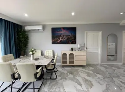 a dining room with a table and white chairs at Phuket 402 in Phuket Town