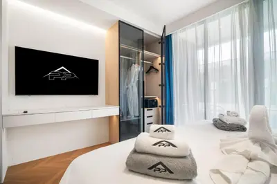 a bedroom with a tv and a bed with towels at Premier Pool View Studio 348 Kora Resort in Phuket Town