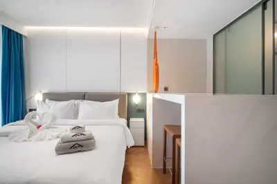 a bedroom with a white bed with towels on it at Premier Pool View Studio 348 Kora Resort in Phuket Town