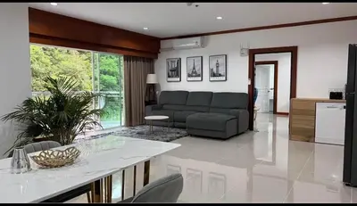 a living room with a couch and a table at Phuket 604 in Phuket Town