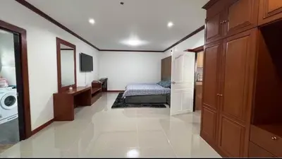 a bedroom with a bed and a washing machine at Phuket 604 in Phuket Town