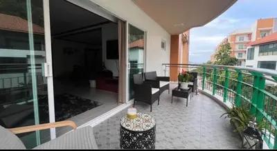 a balcony with a table and chairs on a building at Phuket 604 in Phuket Town