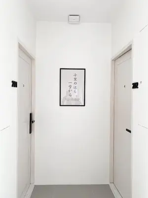 a white room with two doors and a picture on the wall at Tatami Hotel Phuket in Ban Ket Ho