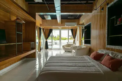 a large bedroom with a large bed and chairs at The Garden Escape Villa, Private Tropical Hideaway in Rawai Beach