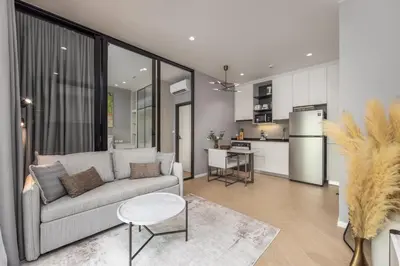 a living room with a couch and a kitchen at Porto 1BR Pool Access Suite at Title Legendary in Bang Tao Beach