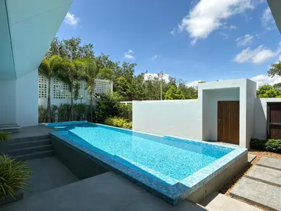 a swimming pool in the backyard of a house at Clover Residence Villa Phuket in Koh Lone
