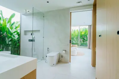 a bathroom with a toilet and a glass shower at Brand New Asherah Pool Villa next to Bangtao Beach VVPHU52 in Ban Riang