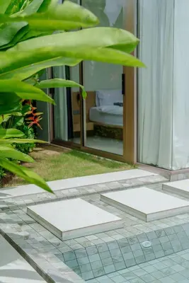 a room with a glass door and a mirror at Brand New Asherah Pool Villa next to Bangtao Beach VVPHU52 in Ban Riang