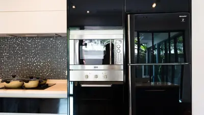 a kitchen with a stove and a microwave at BangTao 3 Bedrooms Bali Tropical Pool Villa Quiet Private Space Guest Preferred in Bang Tao Beach