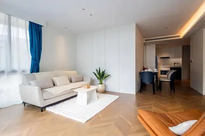 a living room with a couch and a table at KORA 2BR LUXURY POOL VIEW Apartment in Layan Beach