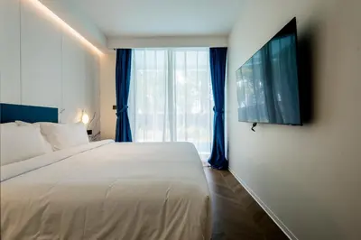 a bedroom with a bed and a large window at KORA 2BR LUXURY POOL VIEW Apartment in Layan Beach