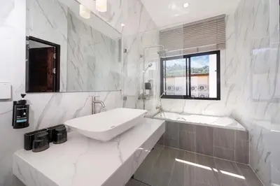 a white bathroom with a sink and a tub at Lelux Villa Kamala - Goldena Twin in Kamala Beach