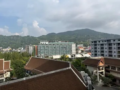 a city with buildings and mountains in the background at Apartment in Patong Beach in Patong Beach