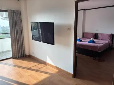 a bedroom with a bed and a mirror and a window at Apartment in Patong Beach in Patong Beach