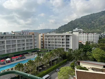 a view of a city with buildings and a mountain at Apartment in Patong Beach in Patong Beach