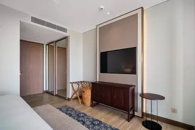 a bedroom with a bed and a flat screen tv at Angsana Oceanview Residences Building 3 in Laguna by Banyan Living in Laguna Phuket