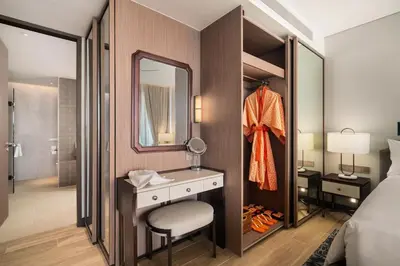 a bedroom with a vanity and a mirror and a bed at Angsana Oceanview Residences Building 2 in Laguna by Banyan Living in Thalang