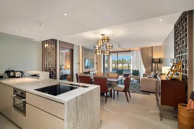 an open kitchen and living room with a dining room at Angsana Oceanview Residences Building 2 in Laguna by Banyan Living in Thalang