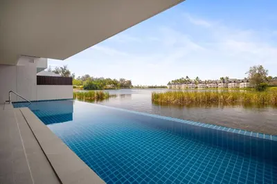a swimming pool with a view of a river at Angsana Oceanview Residences Building 2 in Laguna by Banyan Living in Thalang