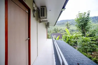 an open door of a building with a balcony at B201 Banjong Studio 3 Minutes To Nai Harn Beach in Rawai Beach