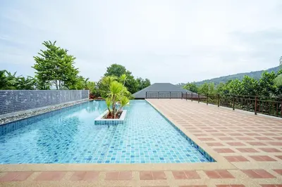 a swimming pool in the middle of a resort at B203 Banjong Studio 3 Minutes To Nai Harn Beach in Rawai Beach