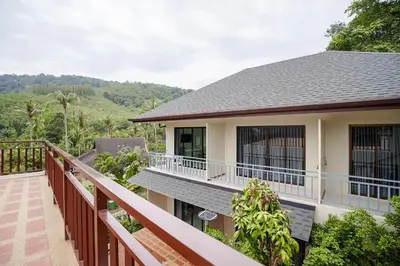 a balcony of a house with a view of the mountains at B203 Banjong Studio 3 Minutes To Nai Harn Beach in Rawai Beach