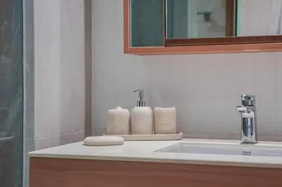 a bathroom with a sink and towels on a counter at Brand New Premium beachfront apartments! in Bang Tao Beach
