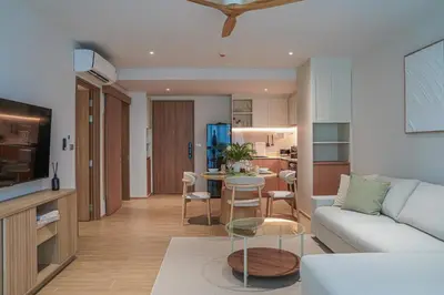 a living room with a couch and a table at Brand New Premium beachfront apartments! in Bang Tao Beach