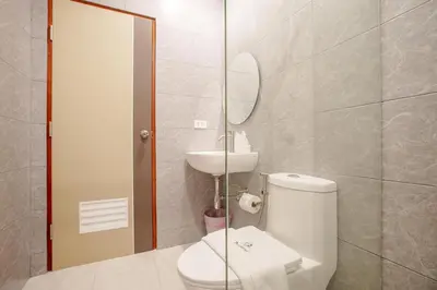 a bathroom with a toilet and a sink and a mirror at B204 Banjong Studio 3 Minutes To Nai Harn Beach in Rawai Beach