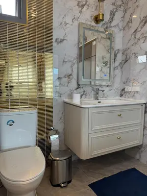 a bathroom with a toilet and a sink and a mirror at Santong Villa Rawai in Rawai Beach
