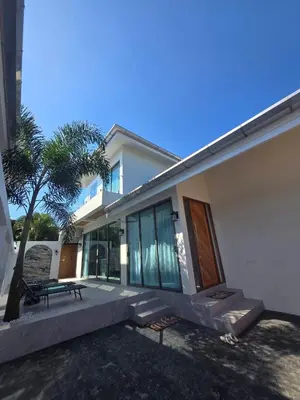 a house with a bench in front of it at Santong Villa Rawai in Rawai Beach