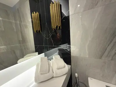 a bathroom with a tub with two white towels on it at Bellevue Lagoon Phuket in Laguna Phuket