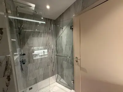 a shower with a glass door in a bathroom at Bellevue Lagoon Phuket in Laguna Phuket