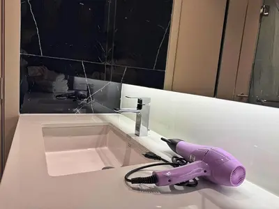 a purple hair dryer sitting on a bathroom sink at Bellevue Lagoon Phuket in Laguna Phuket