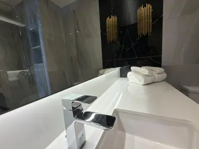 a white bathroom with a sink and a mirror at Bellevue Lagoon Phuket in Laguna Phuket
