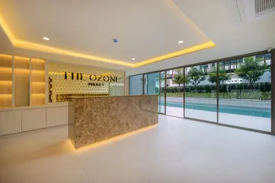 a lobby with a reception desk and a swimming pool at Ozone Сondo Apart Hotel by TropicLook in Laguna Phuket