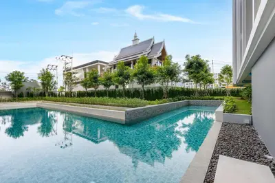a swimming pool in front of a house at Ozone Сondo Apart Hotel by TropicLook in Laguna Phuket