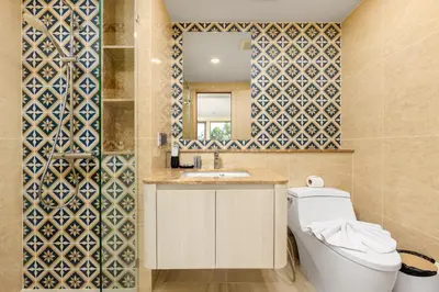 a bathroom with a toilet and a sink and a mirror at Ozone Сondo Apart Hotel by TropicLook in Laguna Phuket